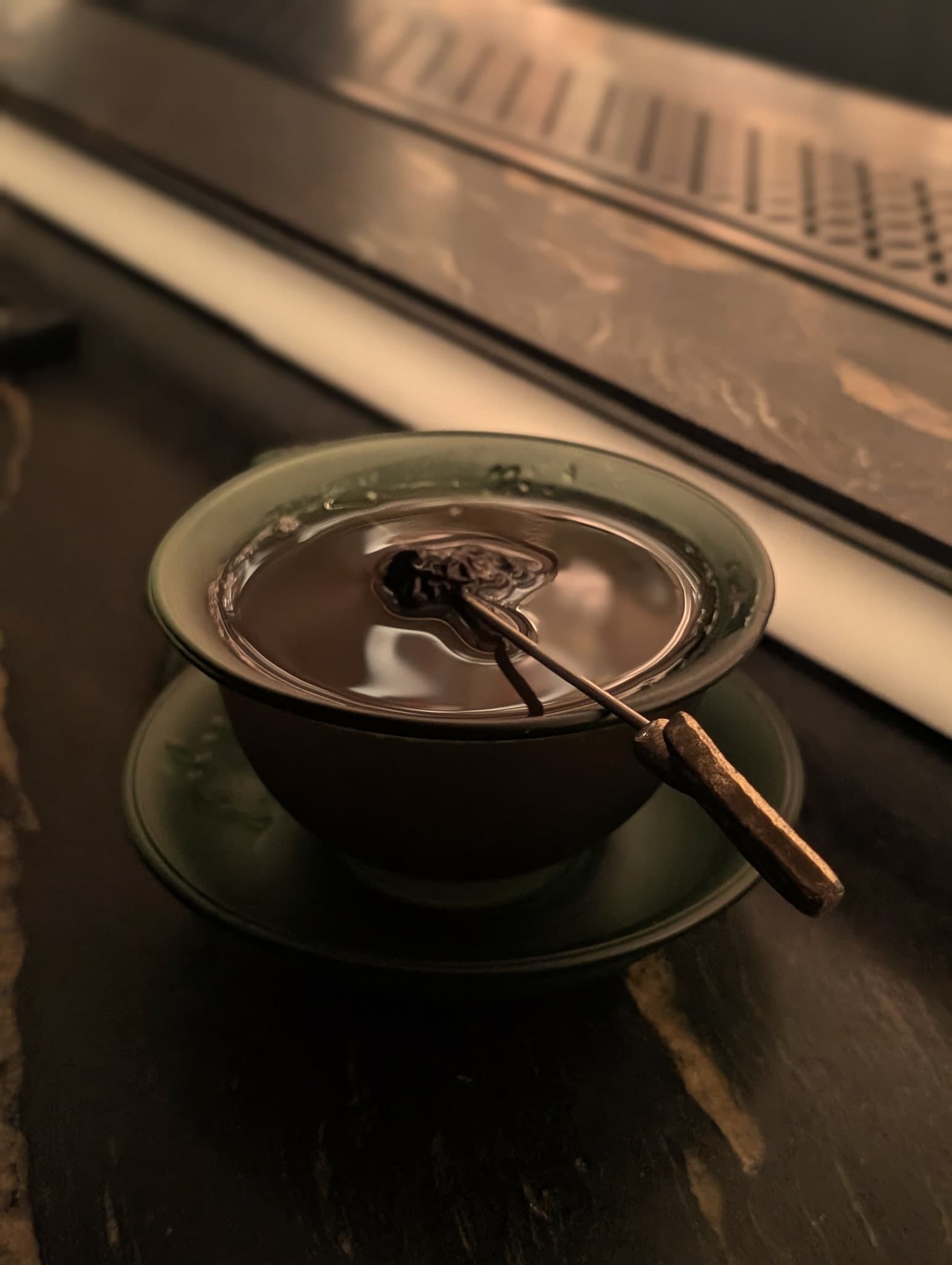 Dragon's Breath at Horatio — served in a celadon gaiwan with a charred cinnamon stir
