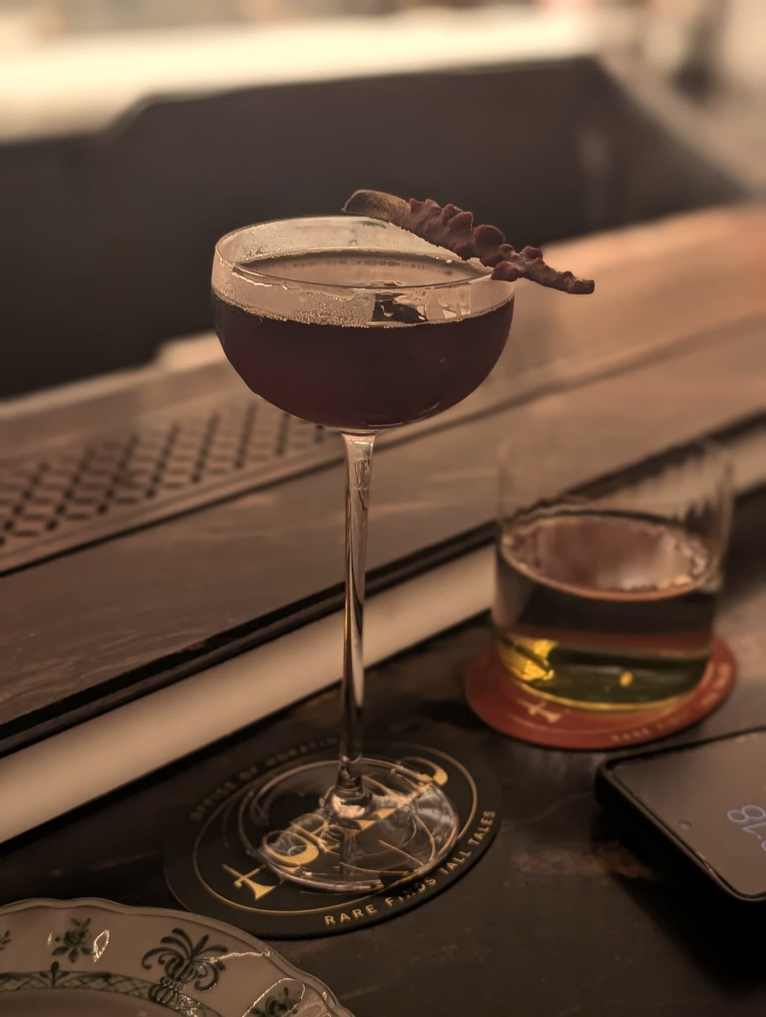 The Gateway at Horatio — deep mahogany manhattan-style coupe with a curled chocolate-dyed citrus peel