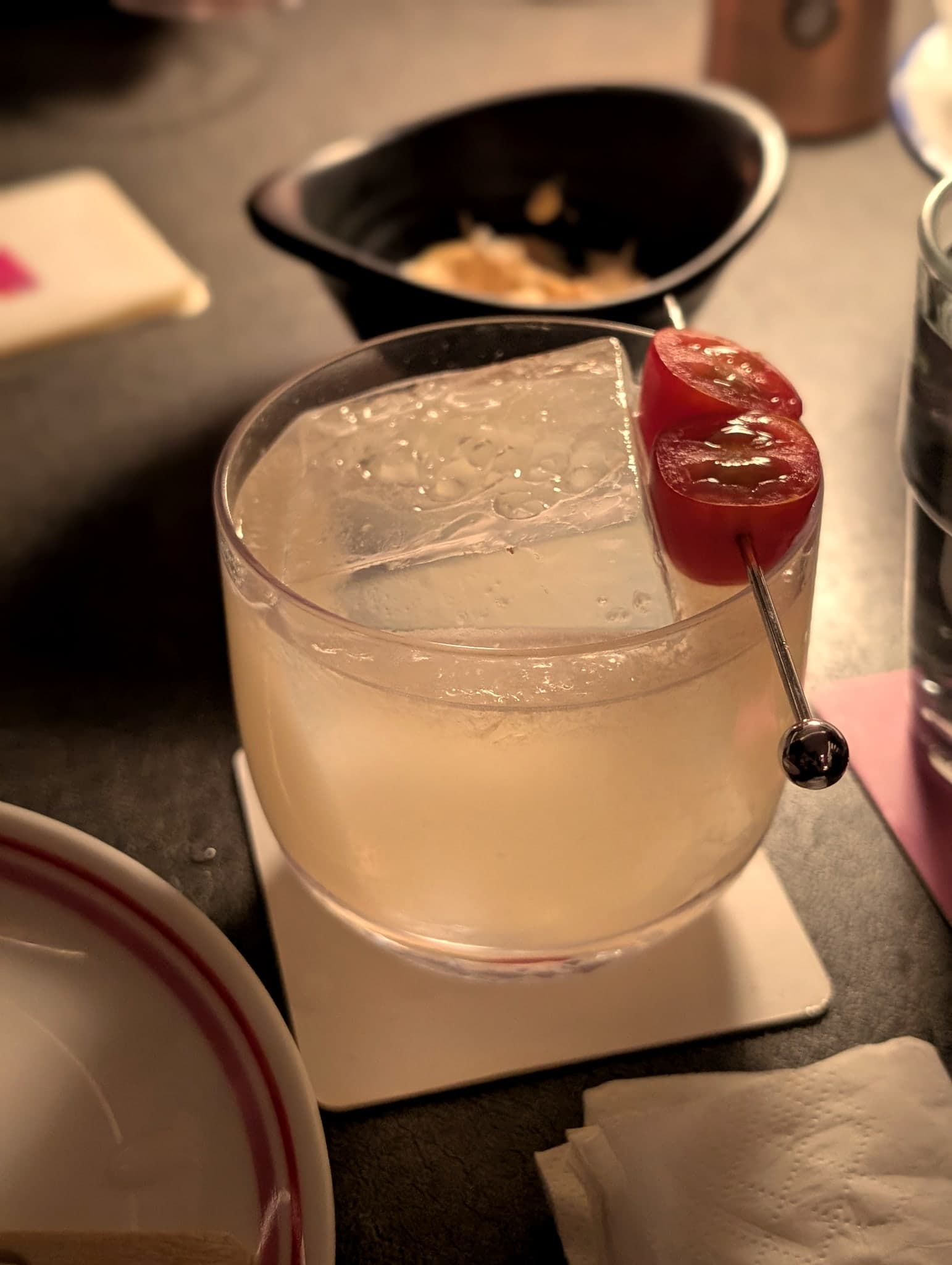 Die Die Must Try at Nutmeg & Clove — pale savoury cocktail garnished with cherry tomatoes and an olive pick